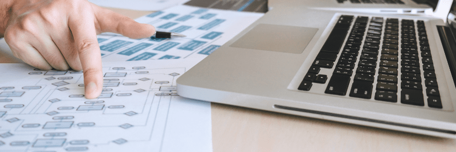 A desk with diagrams and a laptop